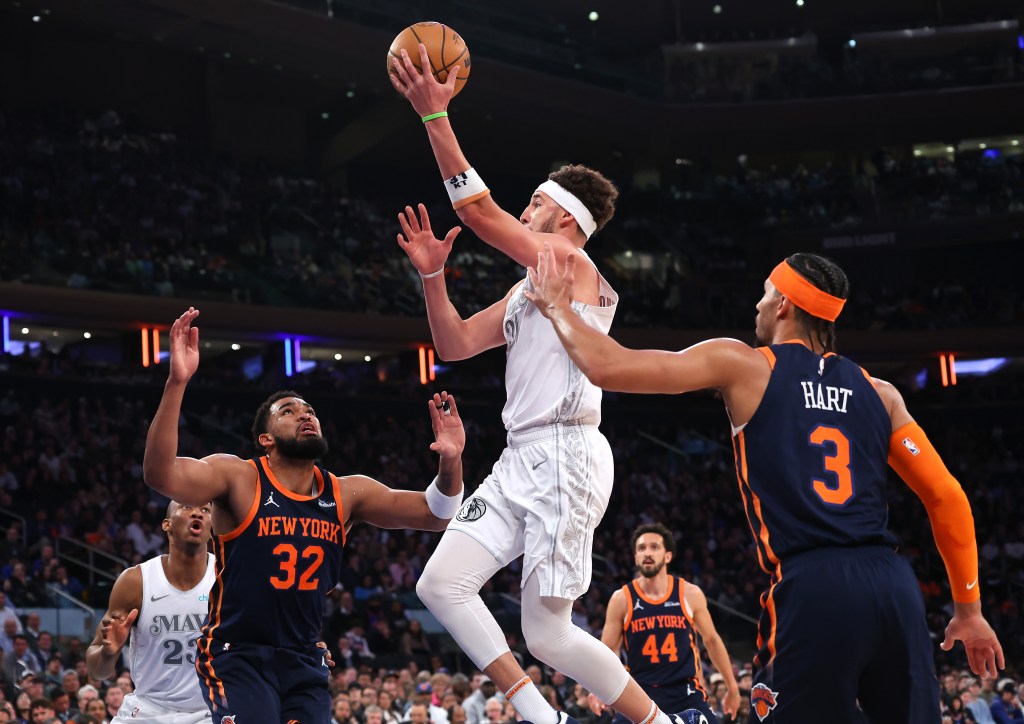 Dallas Mavericks guard Klay Thompson goes up for a shot between New York Knicks center Karl-Anthony Towns and New York Knicks guard Josh Hart.