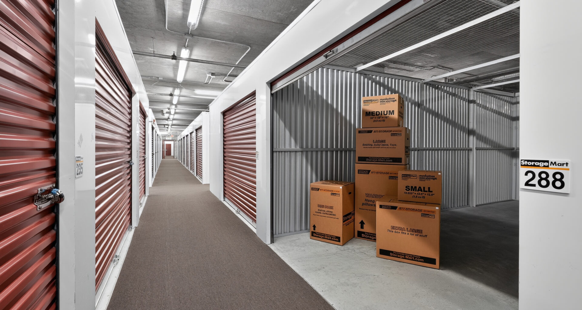 storage boxes stacked in an open, indoor storage unit