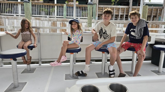 Simon, Jonah, Charlee and Nova aboard Captain Silas’s boat
