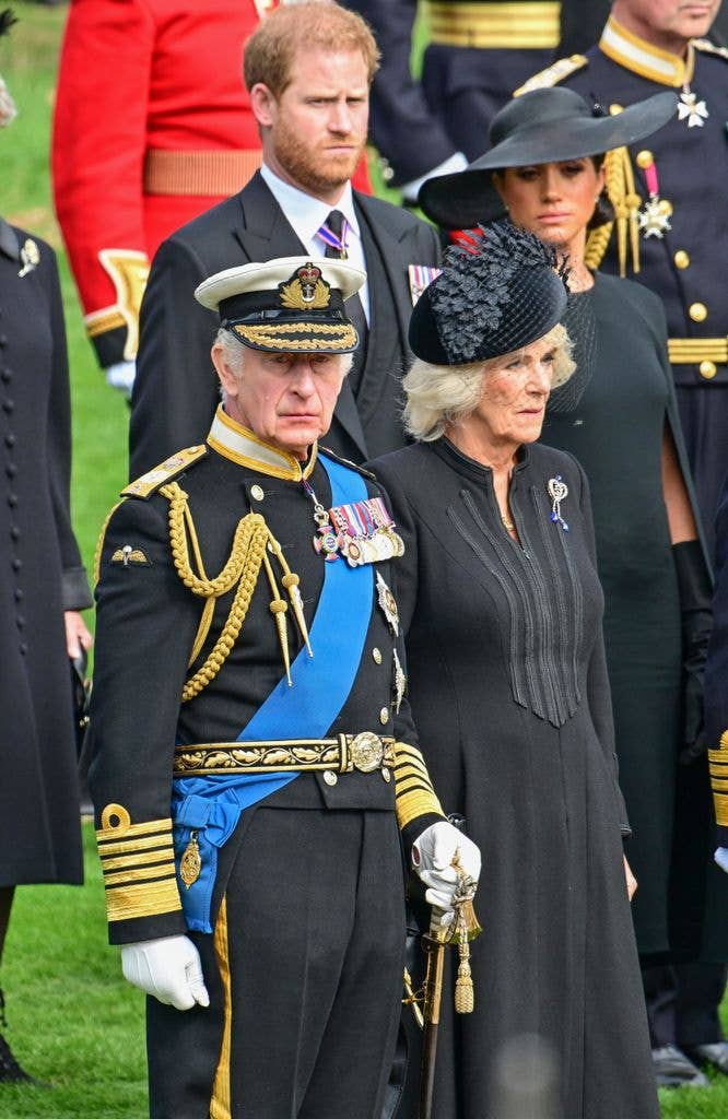 Prince Harry, Duke of Sussex, Meghan, Duchess of Sussex, King Charles III and Camilla, Queen Consort observe the coffin of Queen Elizabeth II as it is transferred from the gun carriage to the hearse at Wellington Arch following the State Funeral of Queen Elizabeth II at Westminster Abbey on September 19, 2022 in London, England. 