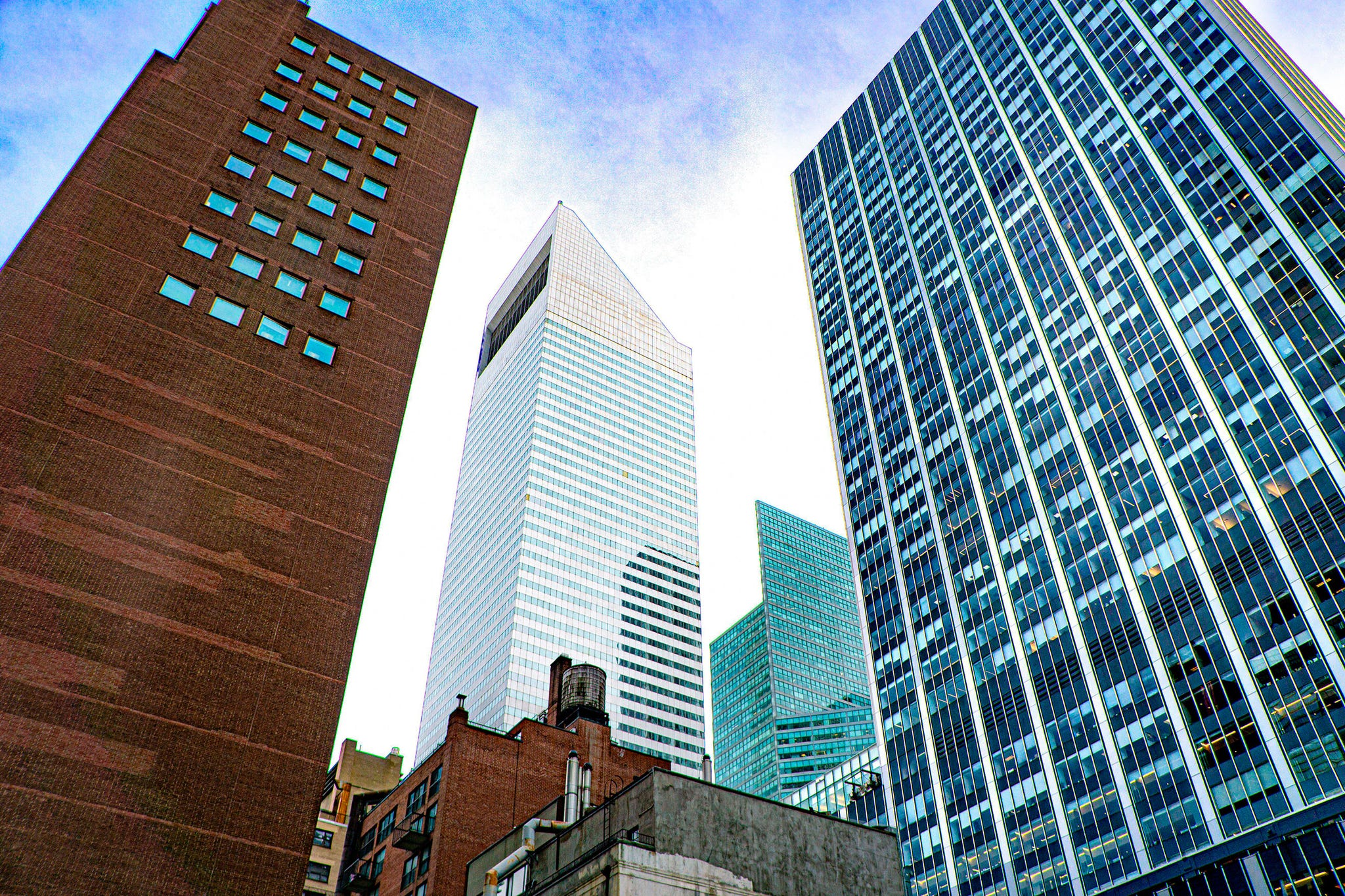 Tall buildings in an urban skyline under a clear blue sky.