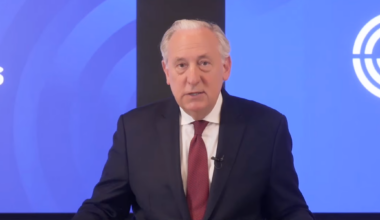 A photo of fingerhut speaking from a podium.