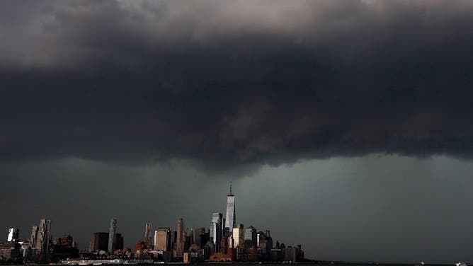 FILE - HOBOKEN, NJ - MAY 20 A thunderstorm passes over the skyline of lower Manhattan and One World Trade Center in New York City on May 20, 2026, as seen from Hoboken, New Jersey.
