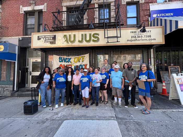 Group standing in front of an East Harlem building