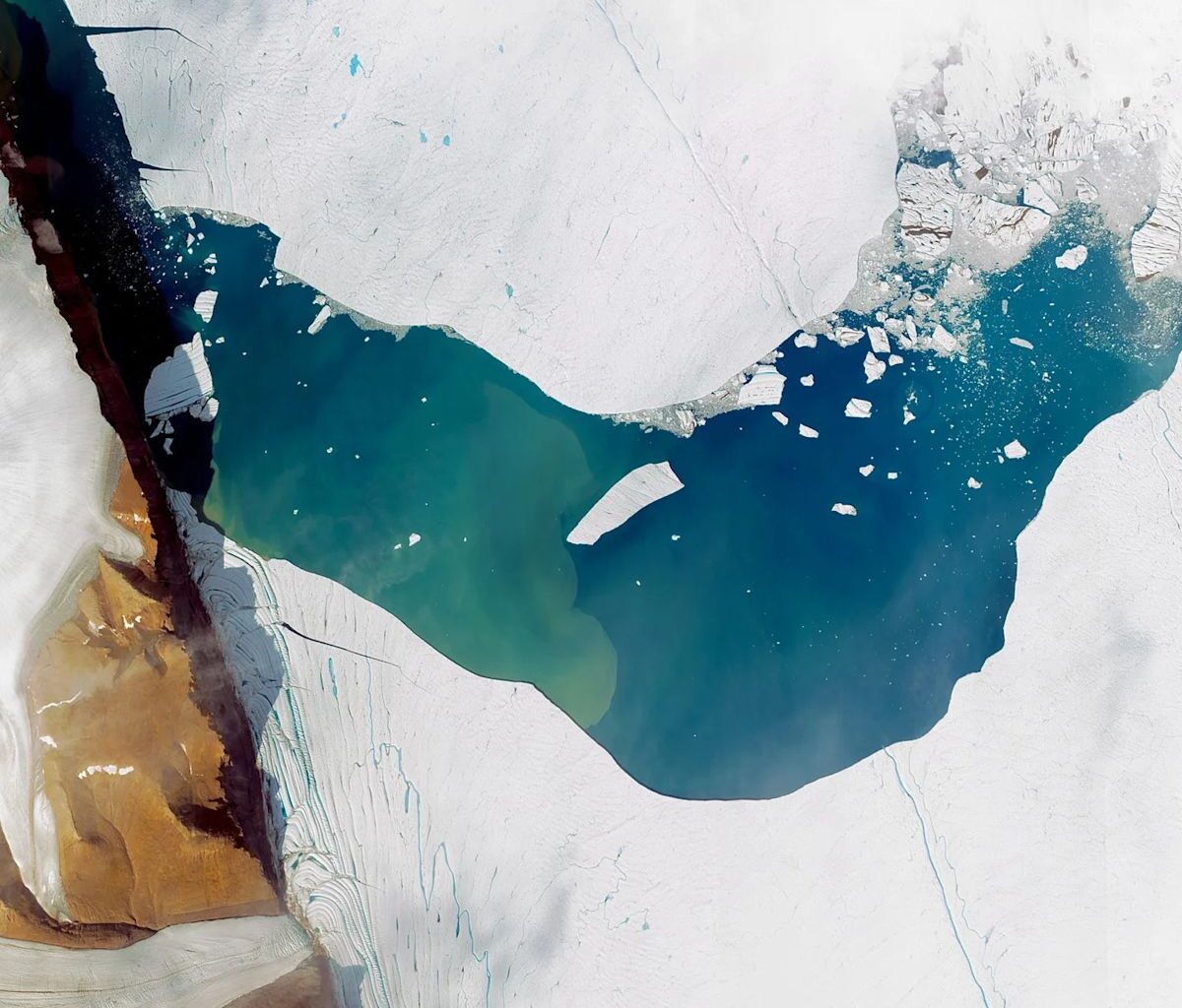 Large chunk of ice the size of Manhattan breaks away from glacier and forms icy island in Greenland