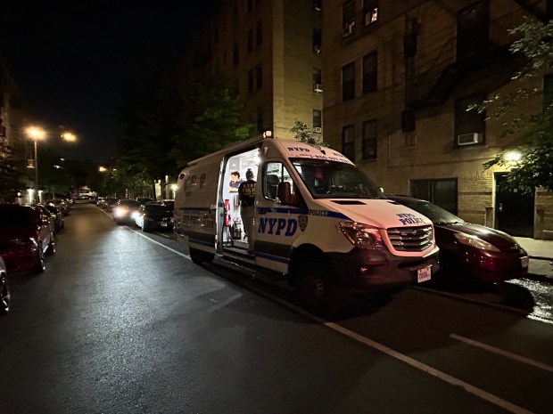 Police on the scene where one man was killed, another injured, in an attack outside a Bronx apartment building on Wednesday, August 26, 2026. (Kerry Burke / New York Daily News)