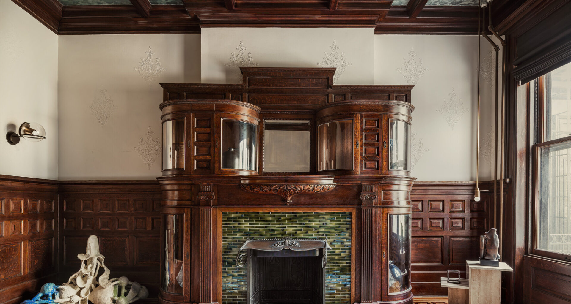 ROOM WITH COFFERED CEILING GRAND FIREPLACE WAINSCOTING