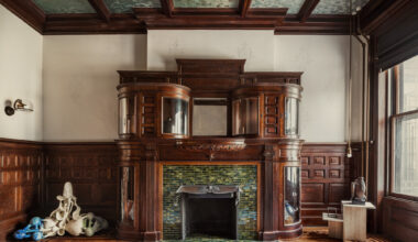 ROOM WITH COFFERED CEILING GRAND FIREPLACE WAINSCOTING