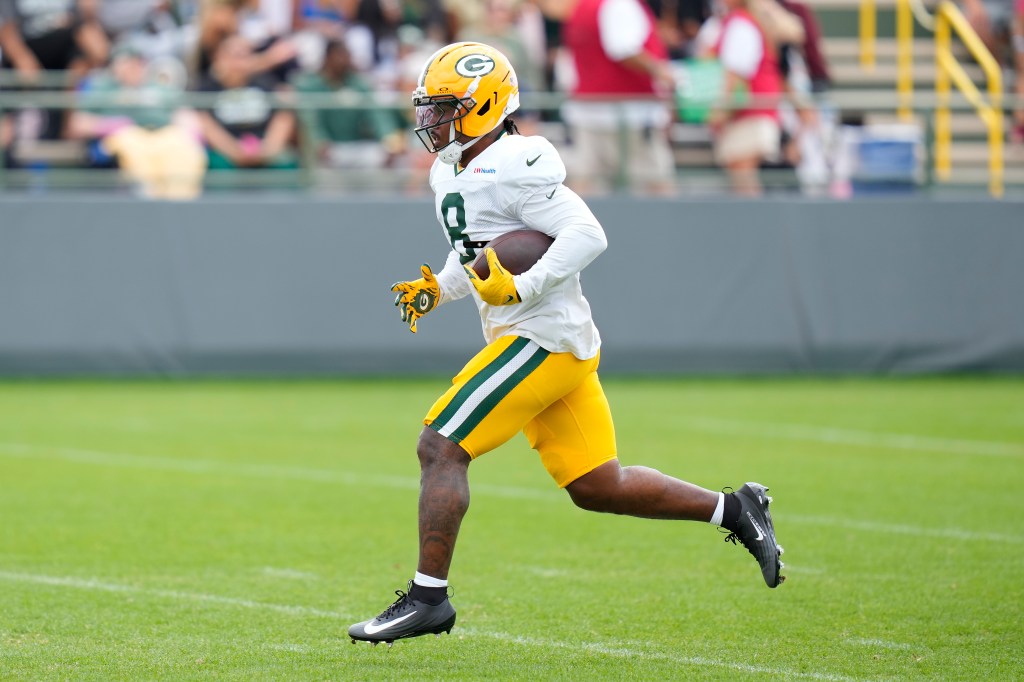 Josh Jacobs of the Green Bay Packers works out before a joint practice with the Arizona Cardinals at Ray Nitschke Field.