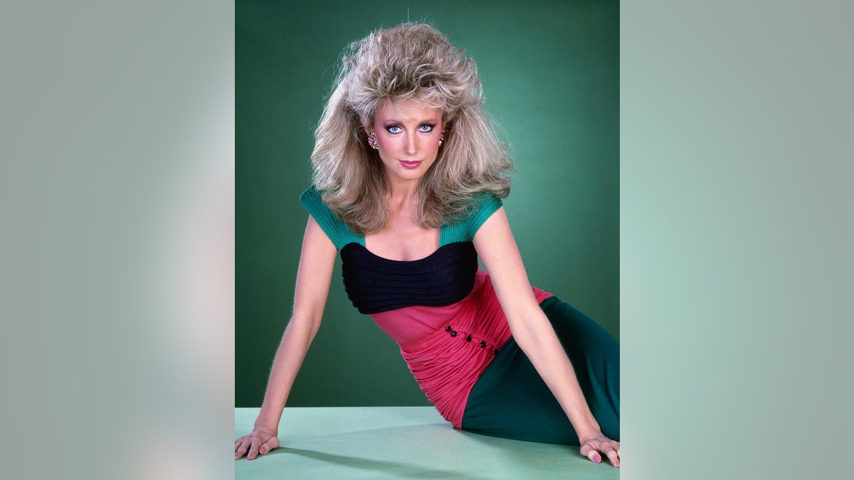 Morgan Fairchild in 1980s attire and big hair for 