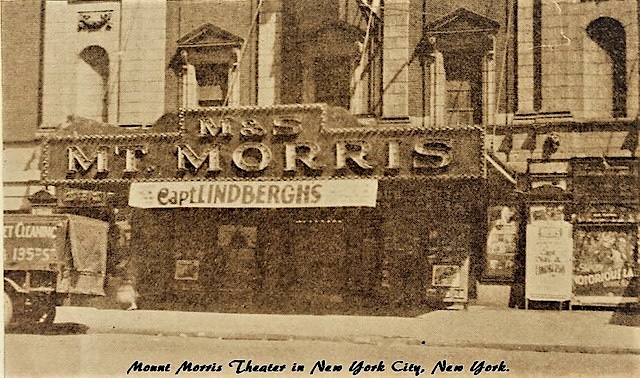 Historical image of the Mount Morris Theater in New York City, featuring a marquee sign with 'Capt. Lindberghs' displayed.