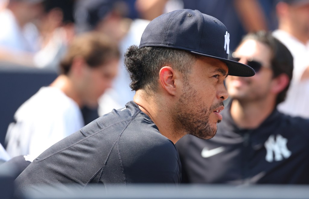 Giancarlo Stanton of the New York Yankees on the dugout fence.