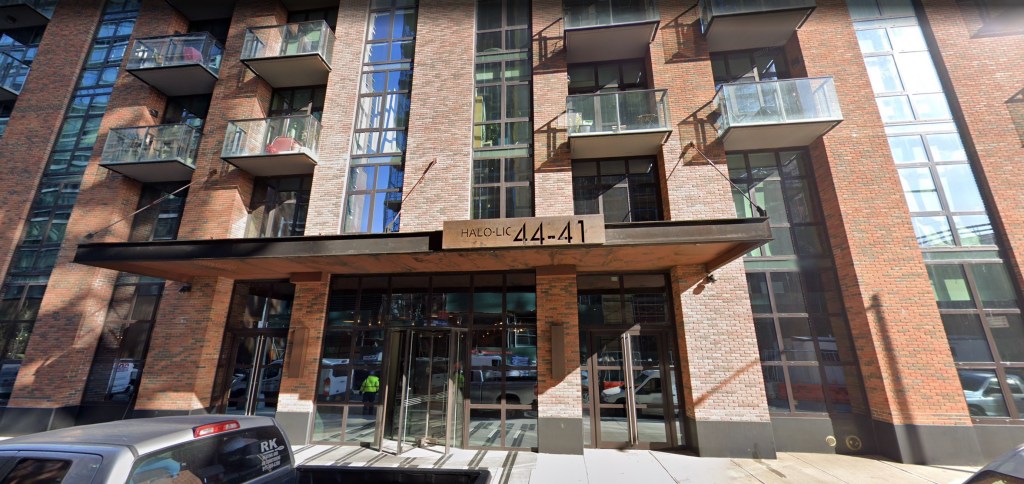 A Google Maps street view of the Halo LIC building in New York City, a tall brick building with many windows and small balconies.