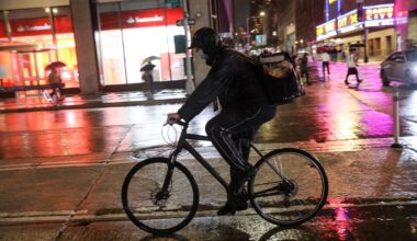A food delivery rider rides a bicycle through the rain during a delivery in midtown Manhattan, New York, on Sept. 23, 2021. (REUTERS/Angus Mordant/File Photo)