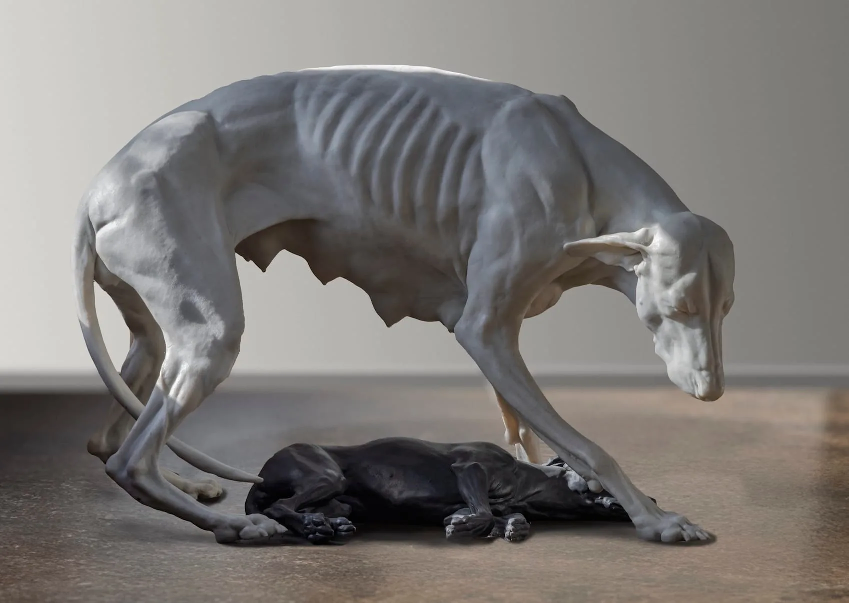 Two intertwined dog sculptures, one white resin and one black porcelain, displayed together.