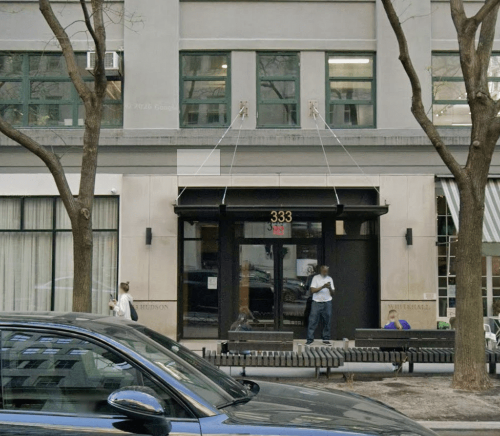 The exterior of a building with the address "333" visible above the entrance.
