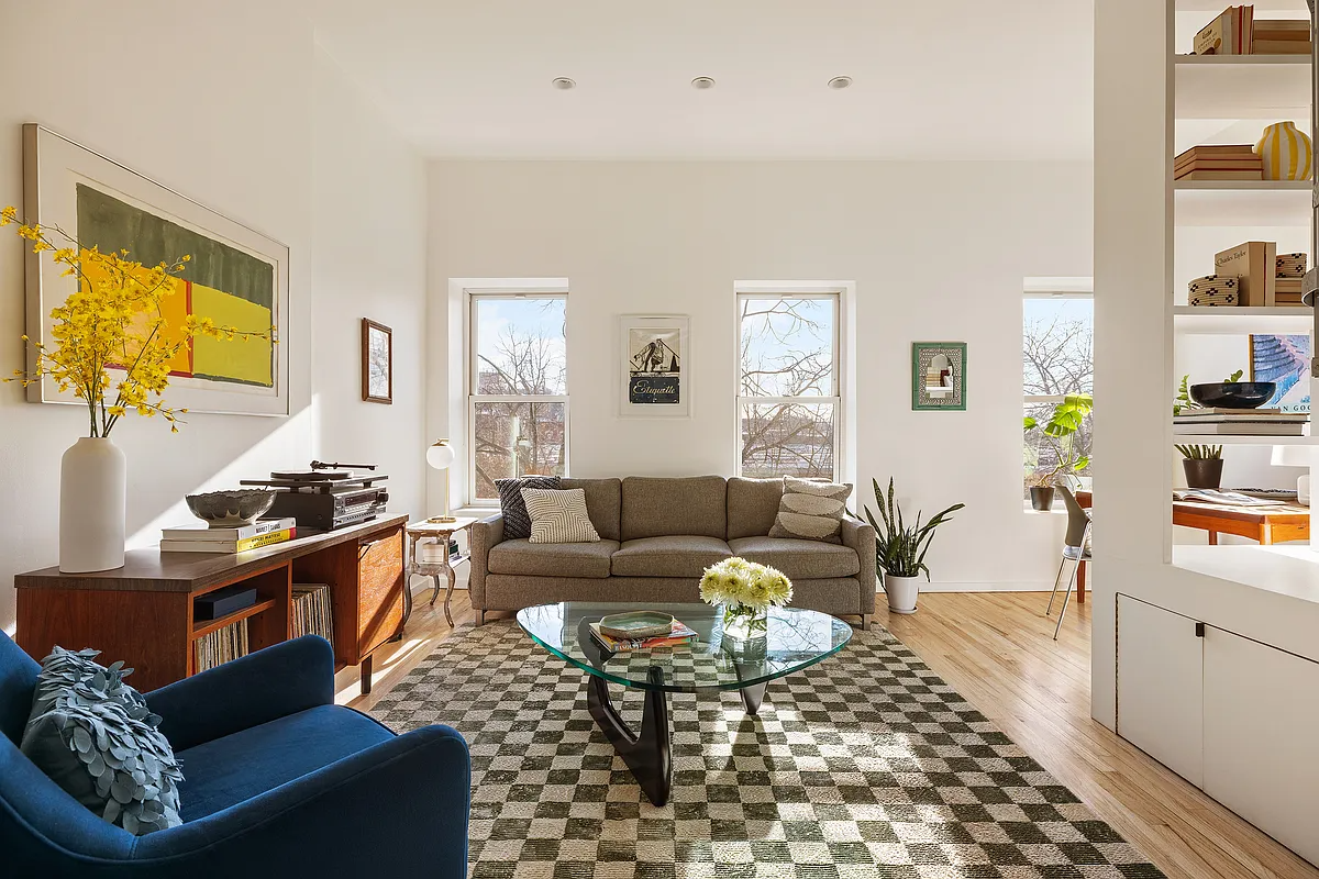 living room with white walls, built-in storage