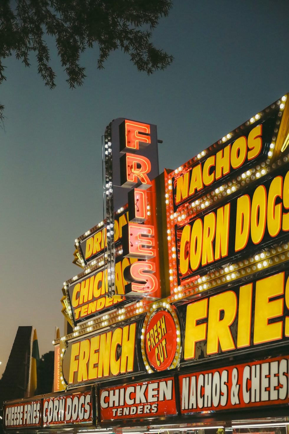 A large neon sign for a french fries restaurant