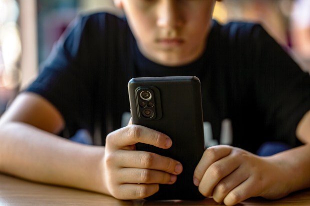 Child on cell phone. (Shutterstock)