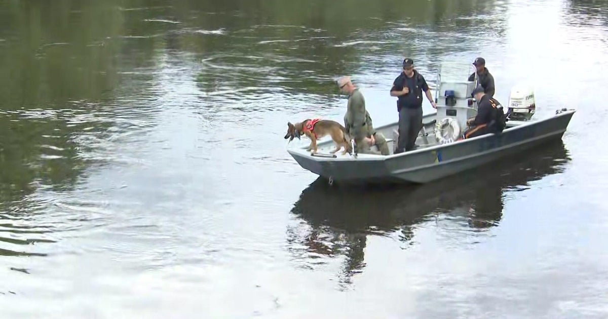 Search crews in a boat on the river