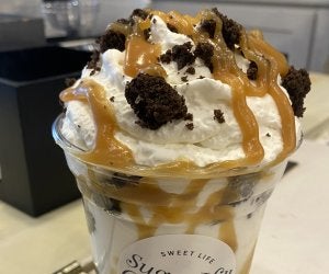 milkshake topped with whipped cream, oreo bits, and caramel