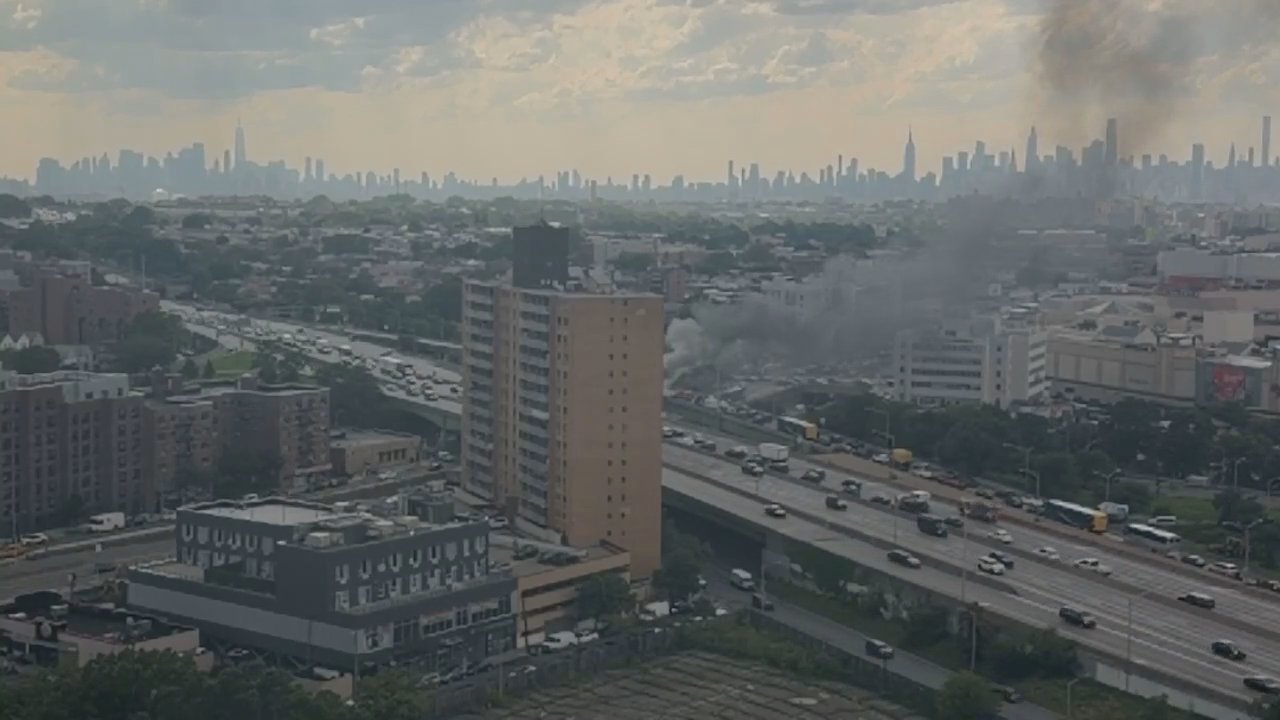 A large plume of smoke drifted over the Queens Center mall as firefighters battled the truck fire on the westbound lanes on the Long Island Expressway. 