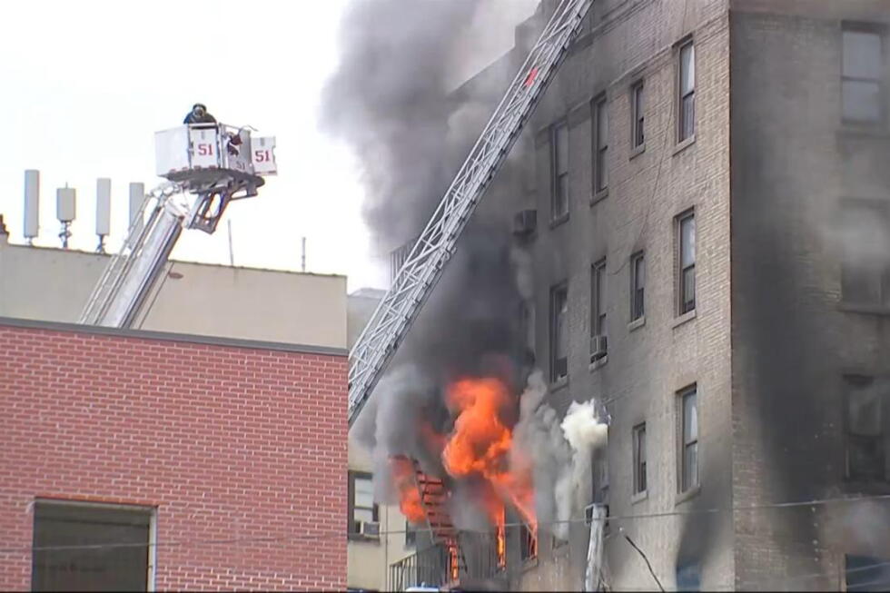 Fire crews battle a large fire at an apartment building in the Bronx