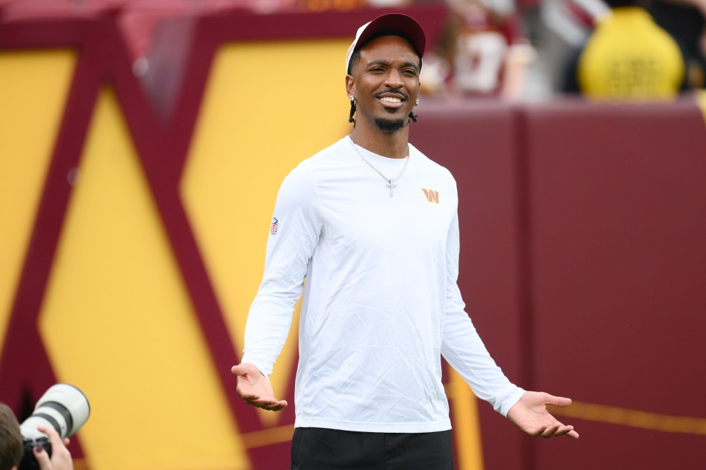 Washington Commanders quarterback Jayden Daniels gestures before an NFL preseason football game.