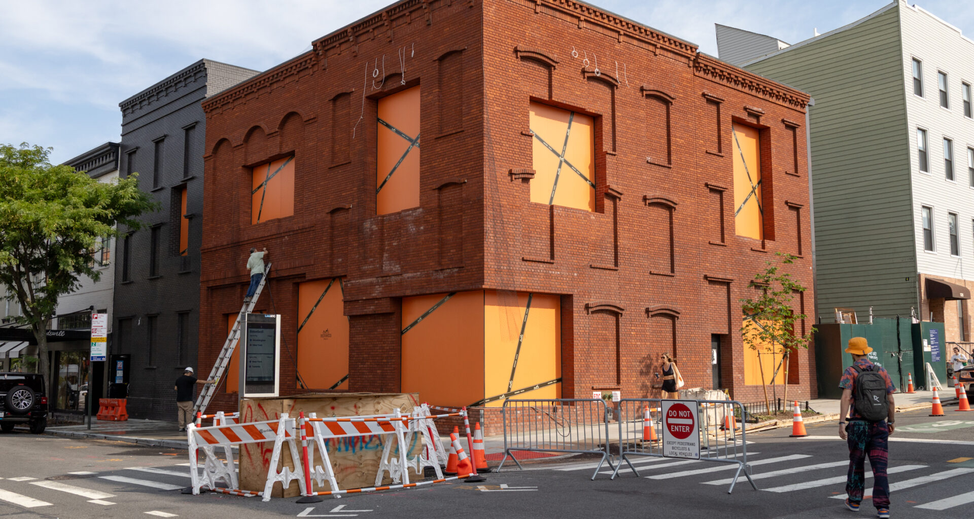 brick building with orange paper in windows