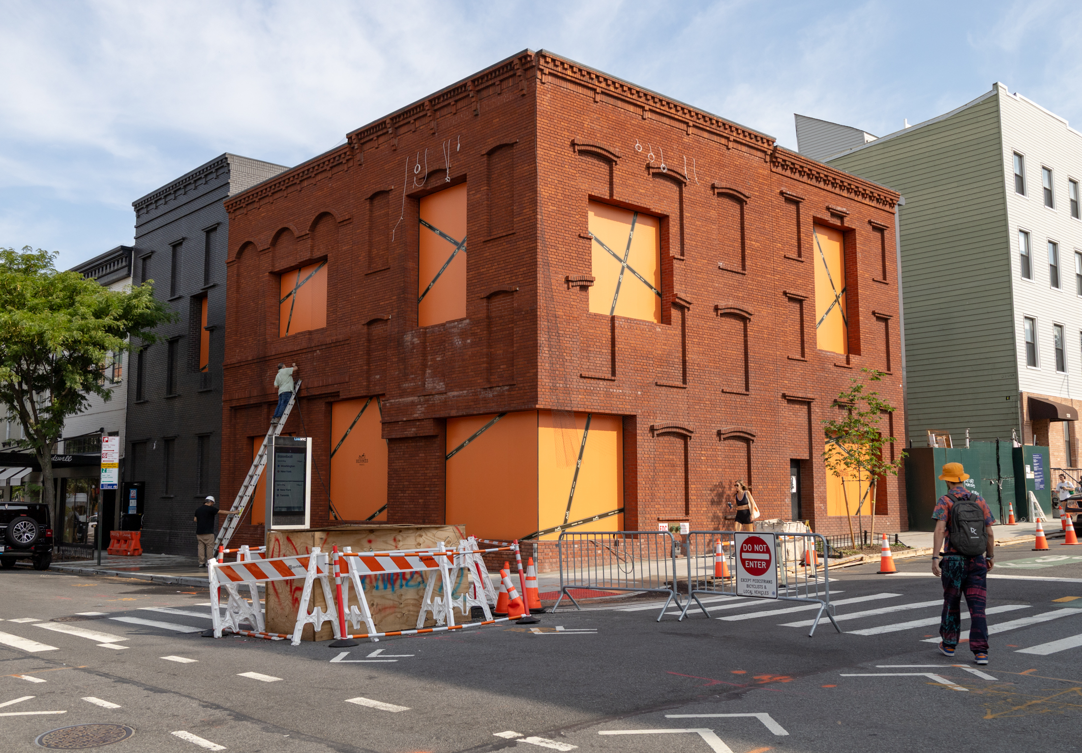 brick building with orange paper in windows