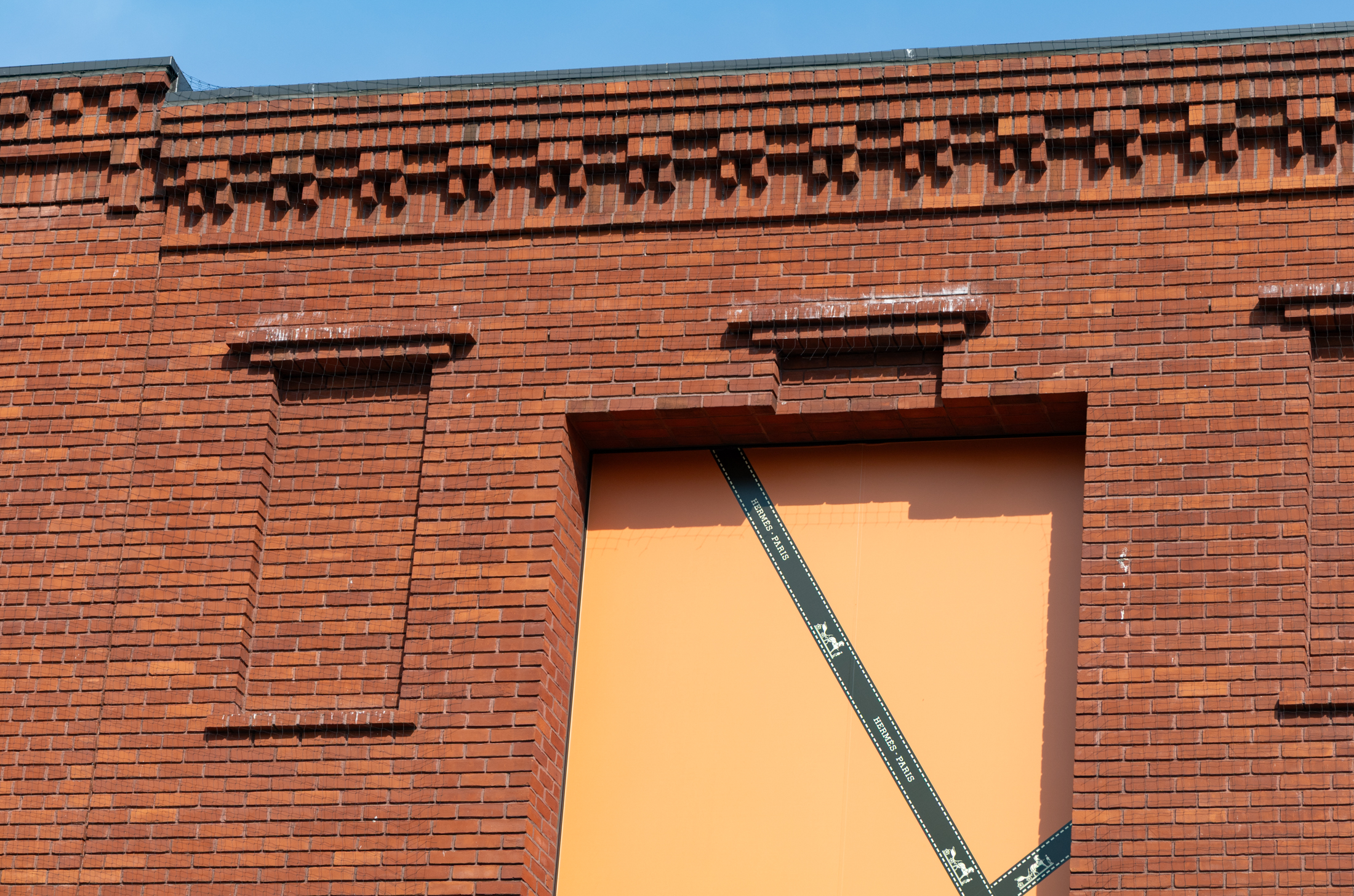 brick building with orange paper in windows