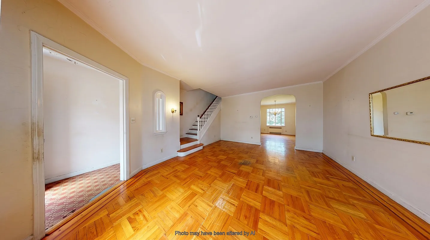 living room with wood floor, tiled entry
