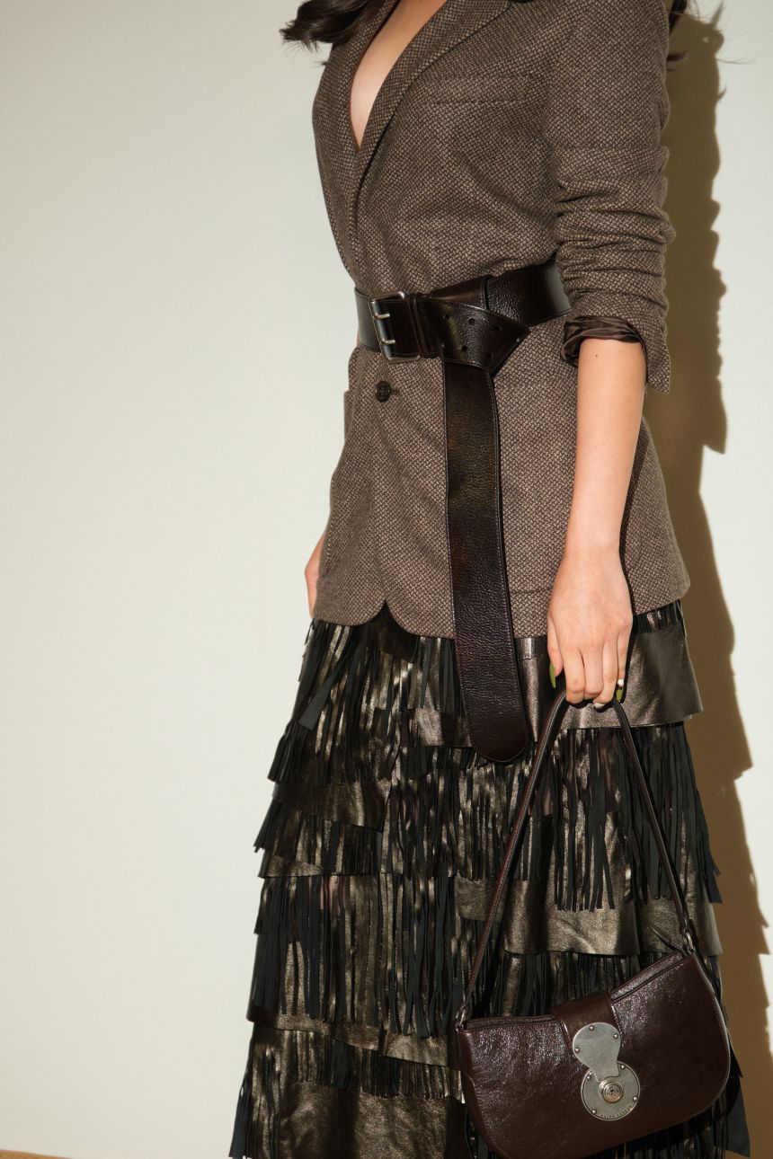 Thai singer and actor Junei Plearnpichaya attends the Ralph Lauren show in a leather fringe statement skirt.