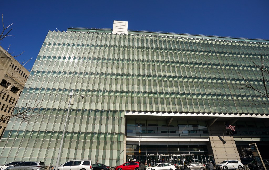 The Bronx County Hall of Justice building under a blue sky.
