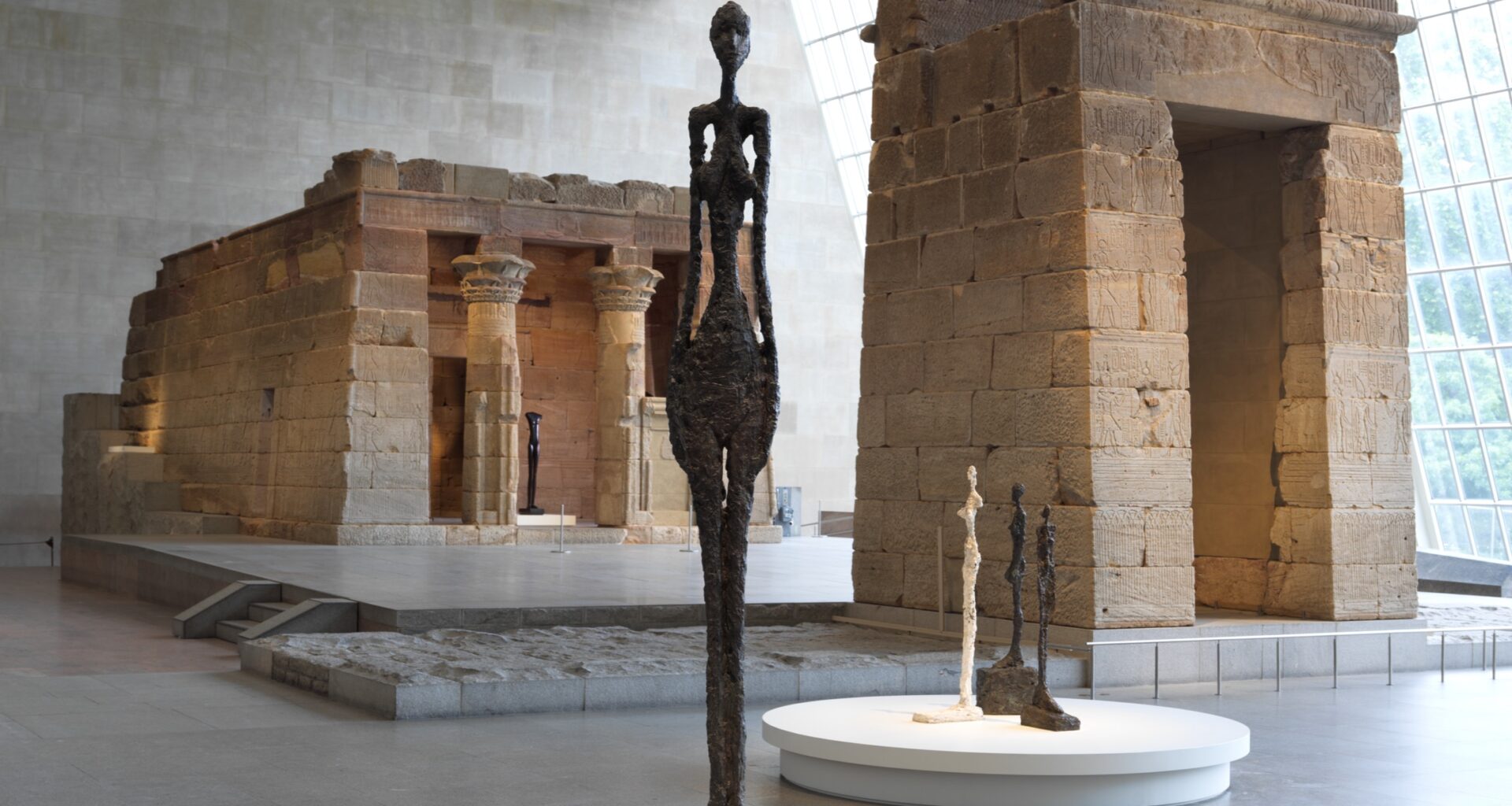 Installation view: Giacometti in the Temple of Dendur, the Metropolitan Museum of Art, New York, NY, 2026. Courtesy the Met. Photo: Anna-Marie Kellen.
