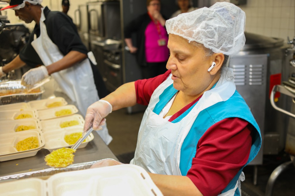 Workers help prepare food at the St. John’s Bread and Life pantry in Bed-Stuy provided fresh produce,