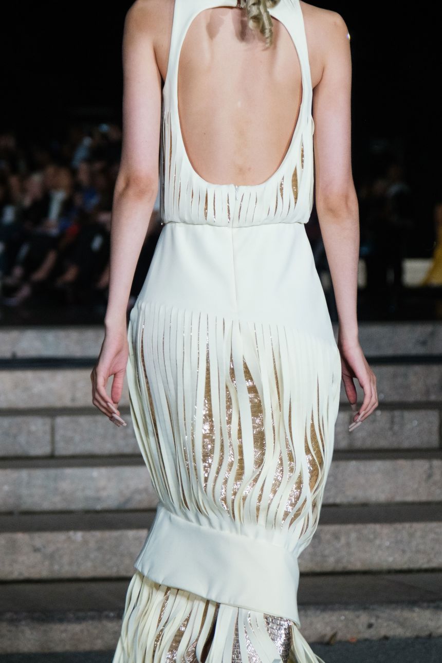 Subtle sequins lay underneath a cream dress at Luar.