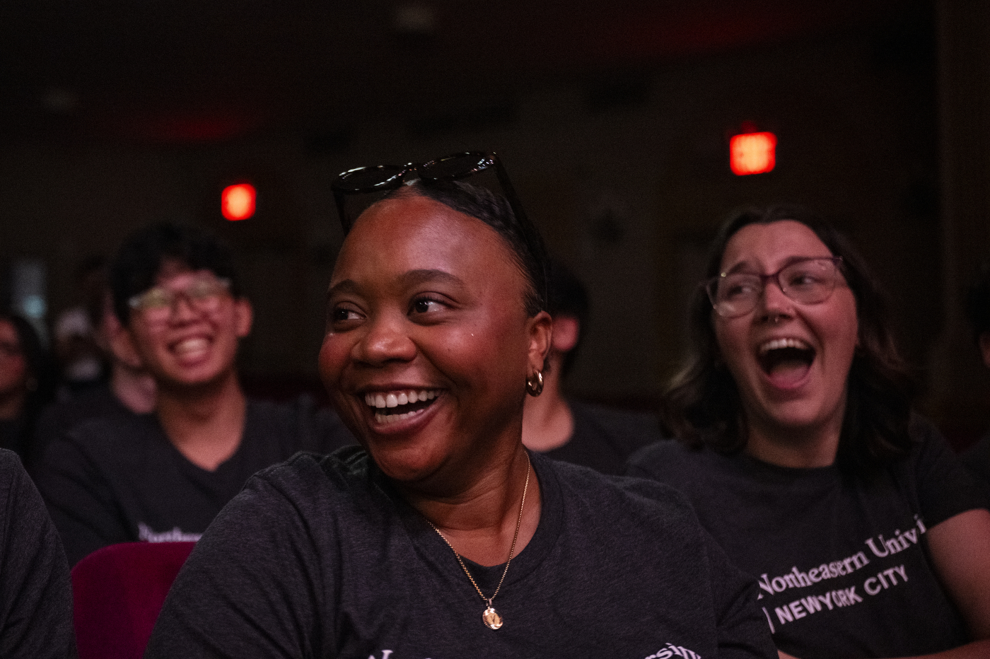 A Northeastern student smiles and laughs with fellow students during the university’s New York City convocation at The Town Hall.