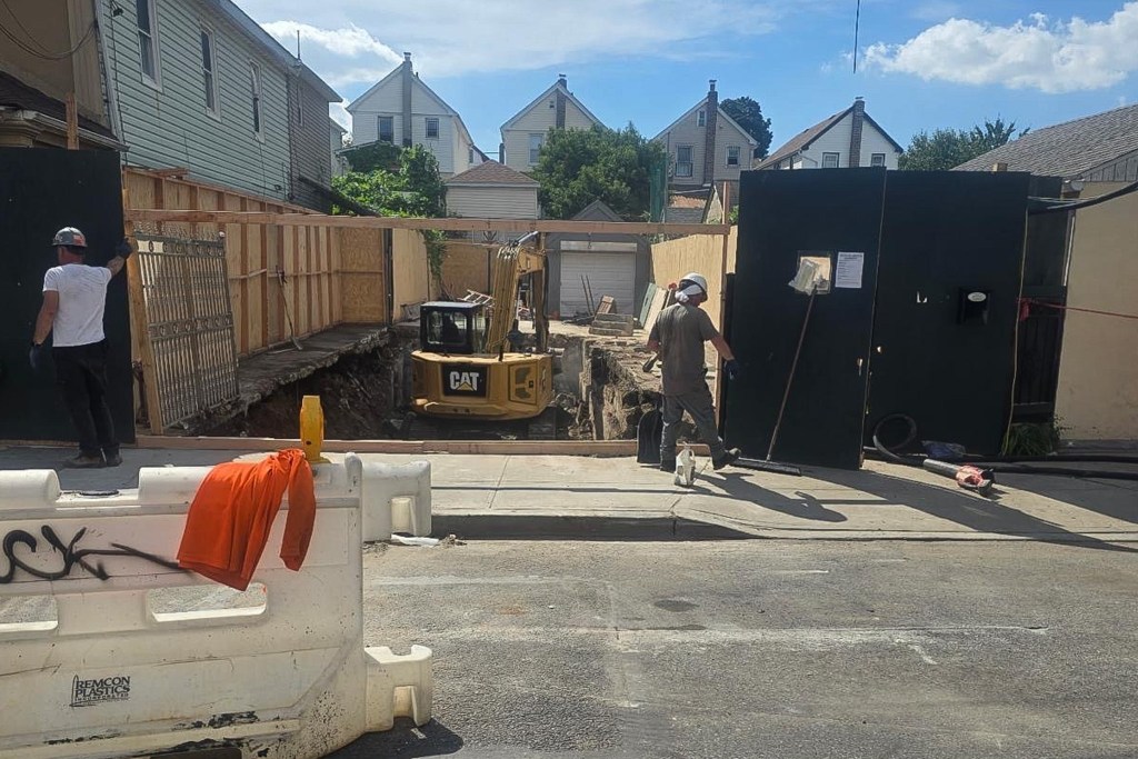 A home in Hollis, Queens undergoes demolition after the Department of Buildings found it structurally unstable because of flood damage,
