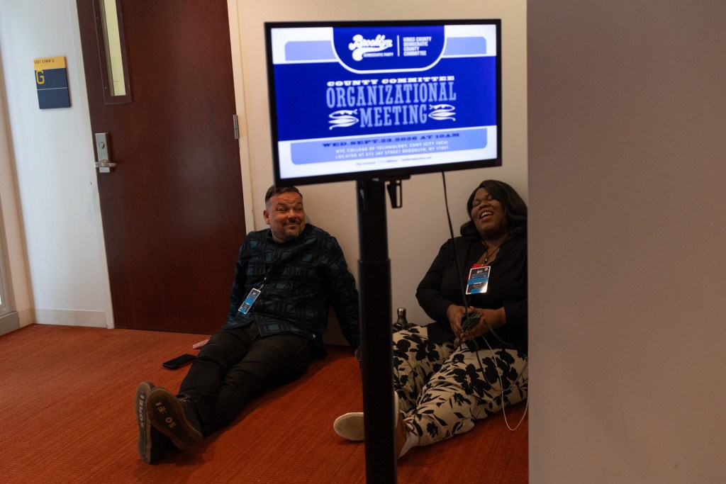 Members of the Brooklyn Democratic county committee wait while a meeting in Downtown Brooklyn was delayed by hours,