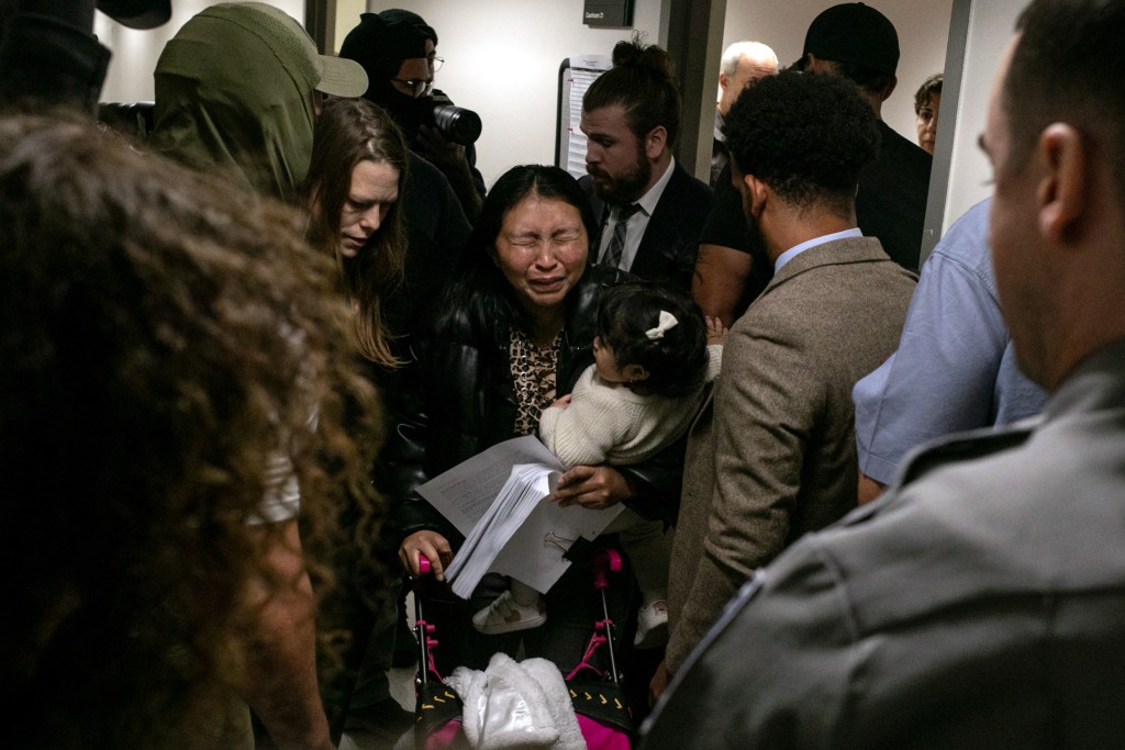 A mother was overcome with emotion after immigration agents detained her partner following a court hearing inside 26 Federal Plaza.