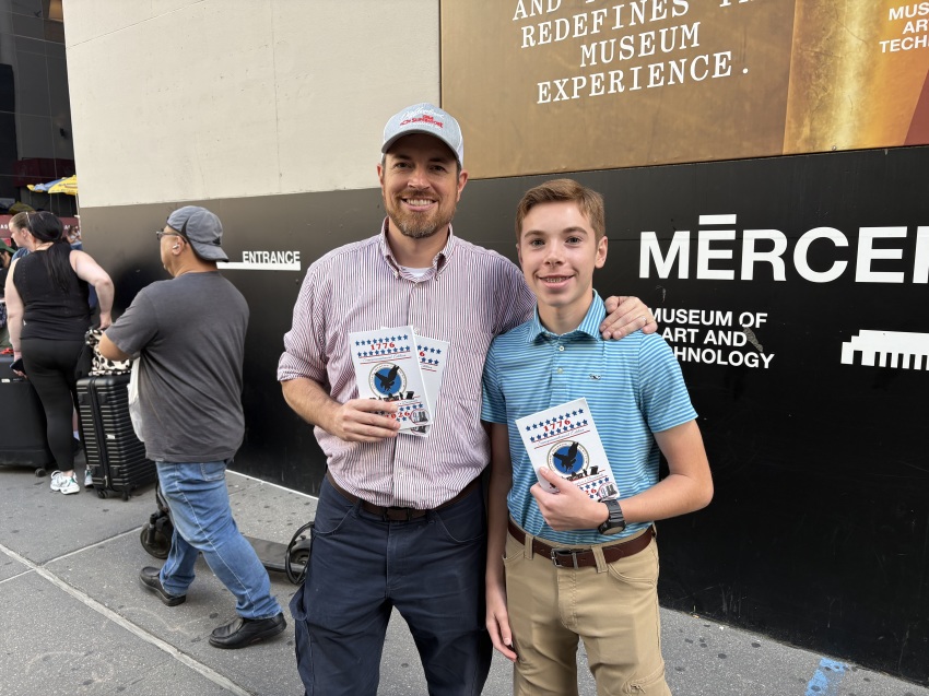 Pastor Jonathan Osborne (L) of Free Will Baptist Church in Rockingham, North Carolina, and his son distribute tracts in Lower Manhattan, New York, on Sept. 11, 2026.