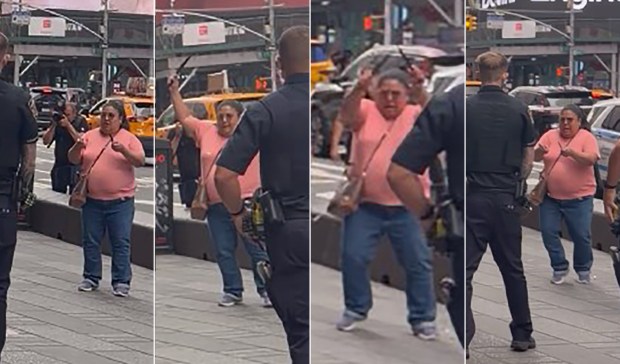 A woman (pictured here in pink) was shot by NYPD cops after refusing to drop two knives she was swinging as she approached them in Times Square Monday, Aug. 31, 2026, at Seventh Ave. and W. 43rd St. in Midtown Manhattan. (Courtesy of Jorge Disla)