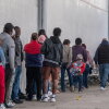 Asylum seekers queue at the entrance of Mexico's Refugee Help Commission and UNHCR offices in Tijuana, Mexico on January 24, 2025. (Photo by Guillermo Arias / AFP) (Photo by GUILLERMO ARIAS/AFP via Getty Images)