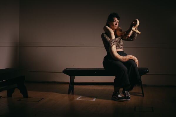 Performance artist Zoe Ziegfeld who plays the part of a snake charmer poses for a portrait with a snake during auditions to select a snake for a part in an adaptation of Mozart’s “Così fan tutte," at the Metropolitan Opera in New York, Friday, Aug. 28, 2026. (AP Photo/Andres Kudacki)