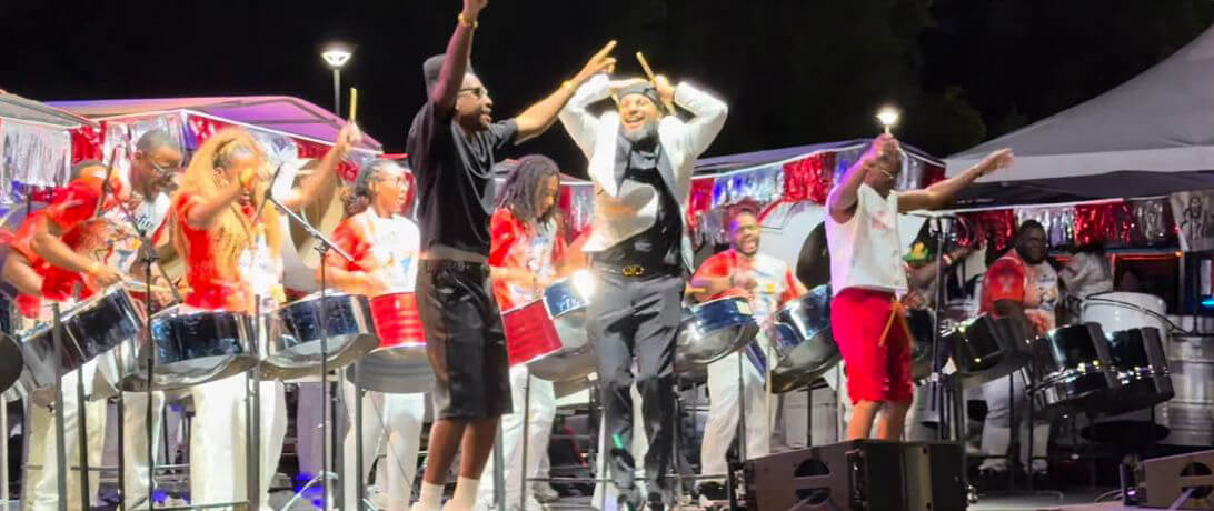 Pan Evolution Steel Orchestra on stage with arranger André White (center) and artists “Full Blown” for New York Panorama 2026