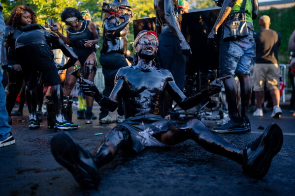 People participate in J'Ouvert festivities ahead of the West Indian Day Parade at sunrise on Labor Day in the Crown Heights and Flatbush neighborhoods of Brooklyn, Monday, Sept. 7, 2026, in New York. (AP Photo/Angelina Katsanis)