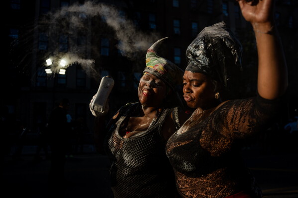 People participate in J'Ouvert festivities ahead of the West Indian Day Parade at sunrise on Labor Day in the Crown Heights and Flatbush neighborhoods of Brooklyn, Monday, Sept. 7, 2026, in New York. (AP Photo/Angelina Katsanis)