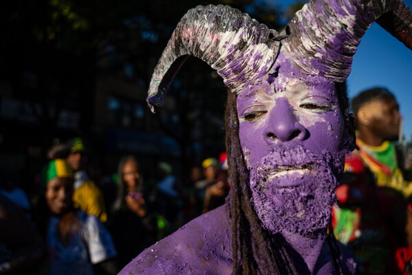 People participate in J'Ouvert festivities ahead of the West Indian Day Parade at sunrise on Labor Day in the Crown Heights and Flatbush neighborhoods of Brooklyn, Monday, Sept. 7, 2026, in New York. (AP Photo/Angelina Katsanis)