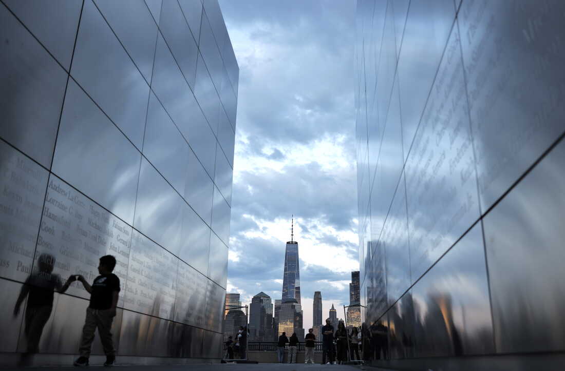 A child walks through the Empty Sky 9/11 Memorial with One World Trade Center and Lower Manhattan in the distance on August 23, 2026 in Jersey City, New Jersey.